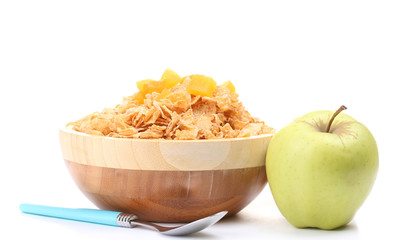 tasty cornflakes in wooden bowl and apples  isolated on white