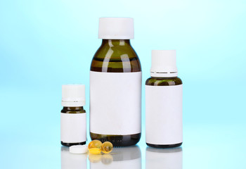 Medical bottles and tablets on blue background