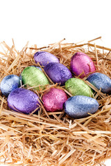Straw nest with chocolate Easter eggs