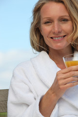 portrait of a woman with glass of orange juice