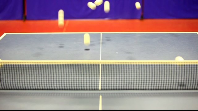 A lot of balls jump in table tennis table.