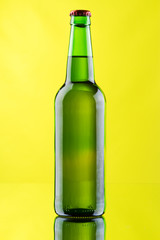 Beer mug and bottle on yellow background