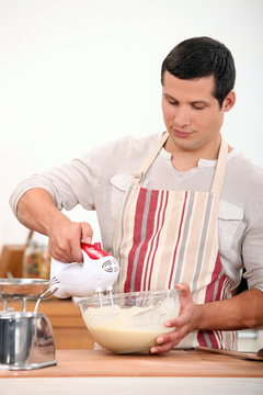 Man using electric whisk