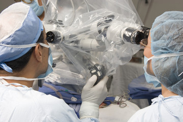 Group Of Surgeons Using Operating