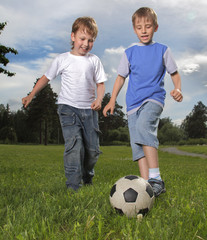 Obraz premium two happy boy play in soccer