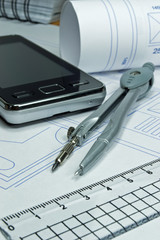 Architecture concept with compass plans and mobile cell phone