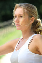 Portrait of blond woman outdoors wearing sportswear