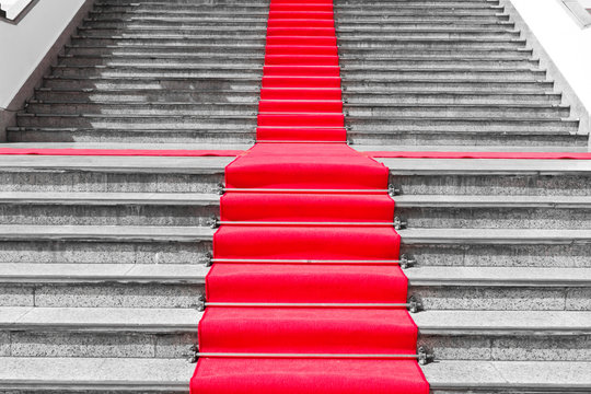 Red carpet way on black and white staircase