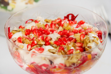 salad with pomegranate seeds,  nuts, cheese