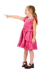 Small nice girl in pink dress pointing  and looking upwards on w