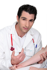 Young doctor giving an injection to a patient