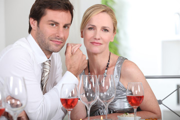Couple sat at table enjoying intimate meal