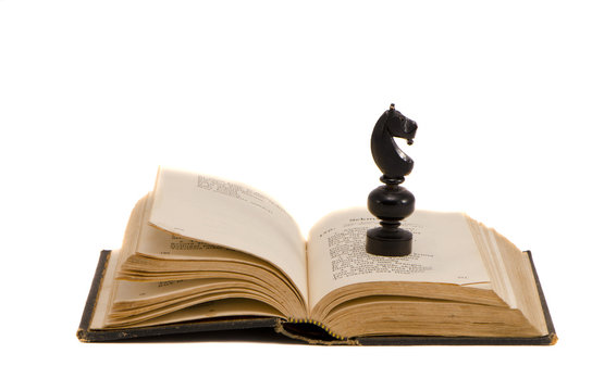 isolated vintage book and chess knight