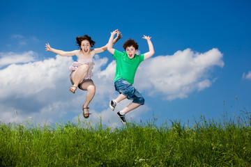 Fototapeta na wymiar Girl and boy running, jumping outdoor