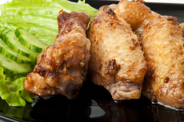 fried chicken, on a dark plate with vegetables