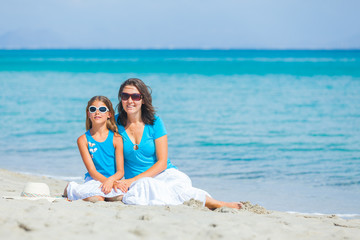 Mother and her little daughter on beach