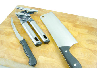 tin opener, knife and cleaver on board