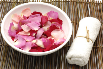 Bowl of rose petal and towel in a spa