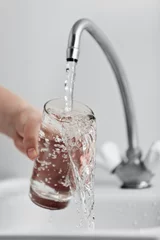 Fotobehang Glass pouring fresh drink water © ia_64