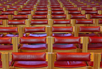 Row upon row of red wooden chairs