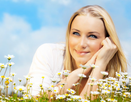 Beautiful Woman Enjoying Daisy Field And Blue Sky