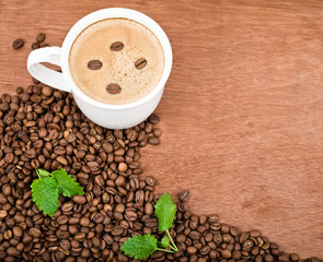 a cup of coffee and roasted coffee beans