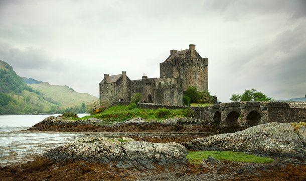 Eilean Donan castle on a cloudy day. low tide. Scotland