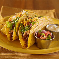 Tacos on a platter with tortillas - mexican food