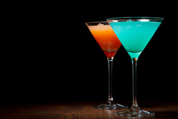 Red and blue cocktails on a black background