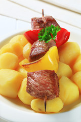 Grilled meat skewer and potatoes