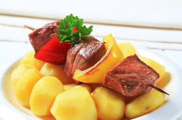 Grilled meat skewer and potatoes