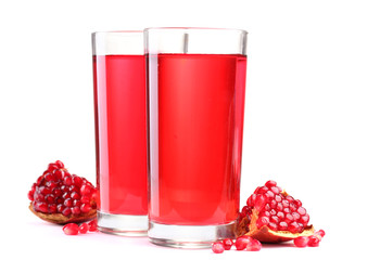 ripe pomergranate and glasses of juice isolated on white.