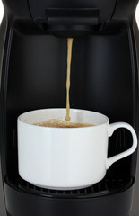 Espresso machine pouring coffee in white cup