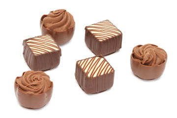 Chocolate pralines on white background