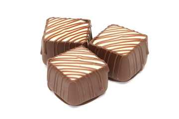 Chocolate pralines on white background