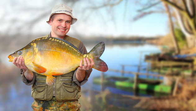 The fisherman with his big Carp at a beautiful lake.