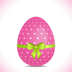 pink polka dot easter egg with green ribbon