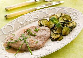 escalope with white wine sauce and sauteed zucchinis