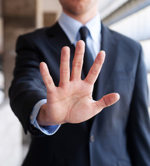 Business man holding out hand, indicating stop