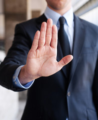 Business man holding out hand, indicating stop