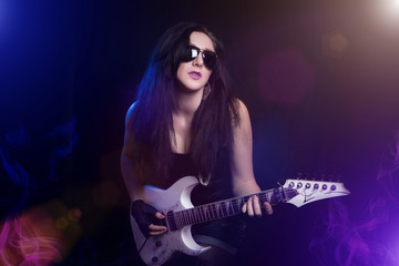 Fototapeta na wymiar fashion girl with guitar playing hard rock