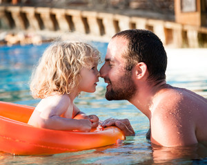 Happy child playing with father