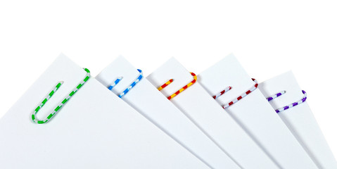 White sheets of paper with colourful paper clips