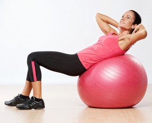 Fototapeta premium Beautiful athlete woman with a fitness ball.