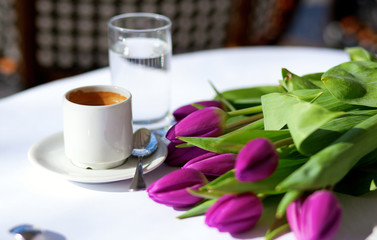 Spring coffee. Cup of fresh espresso and bunch of beautiful tuli