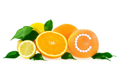 Orange, lemon, grapefruit with vitamin c pills – citrus fruits