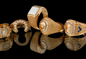 Golden rings with diamonds isolated on black