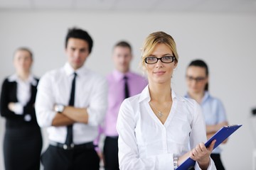 Fototapeta premium business woman standing with her staff in background