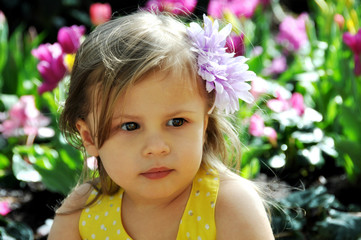 Fototapeta premium Pretty Little Toddler Sitting in Flowers