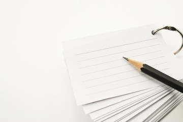 notebook and pencil on white background